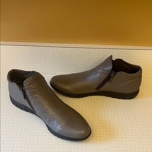 Women’s brown leather and black ankle boots.